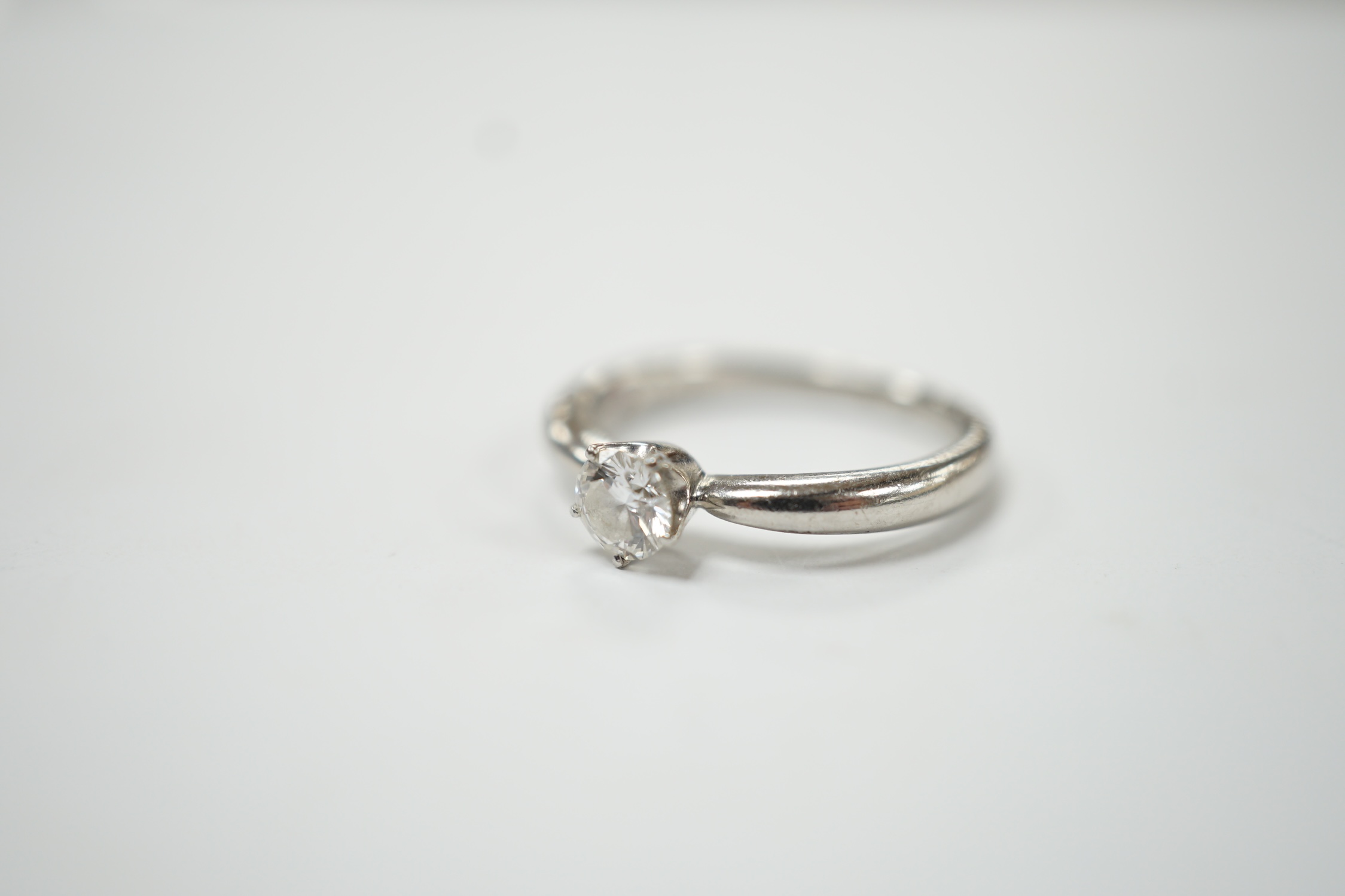 A modern white metal (stamped PT950) and solitaire diamond set ring, size H/I, gross weight 3.8 grams. Good condition.